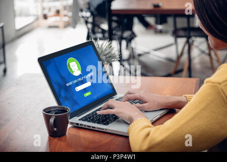 Asia woman ask chat bot function in app on laptop screen looking for customer support online shopping shop with apps,digital marketing concept,artific Stock Photo