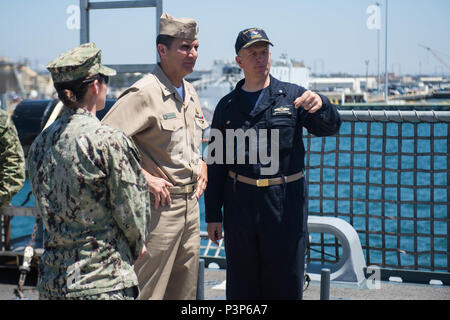 160715-N-WO404-019  SAN DIEGO (July 15, 2016) Rear Adm. Frank Morneau, Commander, Navy Expeditionary Combat Command, center, speaks with Cmdr. Michael Wohnhaas, commanding officer of the littoral combat ship USS Freedom (LCS 1), right, while touring the ship during the Southern California portion of Rim of the Pacific 2016. Twenty-six nations, more than 40 ships and submarines, more than 200 aircraft and 25,000 personnel are participating in RIMPAC from June 30 to Aug. 4. The world’s largest maritime exercise, RIMPAC provides a unique training opportunity that helps participants foster and sus Stock Photo