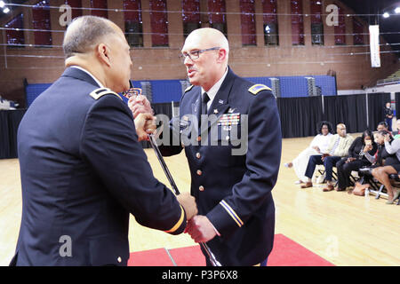 Maj. Gen. William Walker acting Commanding General, District of Columbia National Guard passes the saber to Chief Warrant Officer 5 Command Michael R. Jewett, the newly appointed Command Chief Warrant Officer, D.C. National Guard, signifying his assumption of responsibility May 7, 2017, Washington, D.C. Jewett previously held the position of 7th Aviation Standardization Officer and was the G-3 Senior Warrant Officer with the Army National Guard at National Guard Bureau. Stock Photo