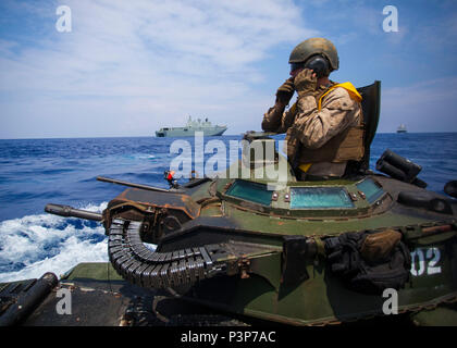 Cpl. Ryan Dills communicates with other assault amphibious vehicles while traveling from amphibious assault ship USS San Diego to Royal Australian Navy Canberra class amphibious ship HMAS Canberra (L02) in the Pacific Ocean, July, 18 2016. The Marines are participating in the Rim of the Pacific 2016, a multinational military exercise, from June 29 to Aug. 4 in and around the Hawaiian Islands. (U.S. Marine Corps photo by Staff Sgt. Christopher Giannetti) Stock Photo