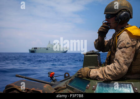 160718-M-OI464-135 PACIFIC OCEAN (July 18, 2016) – Cpl. Ryan Dills communicates with other assault amphibious vehicles while traveling from amphibious assault ship USS San Diego to Royal Australian Navy Canberra class amphibious ship HMAS Canberra (L02). The Marines are participating in the Rim of the Pacific 2016, a multinational military exercise, from June 29 to Aug. 8 in and around the Hawaiian Islands. Participation in RIMPAC will help us develop mutual trust and respect across the joint and combined team through increased understanding of allied and partner cultures, competencies, and ca Stock Photo