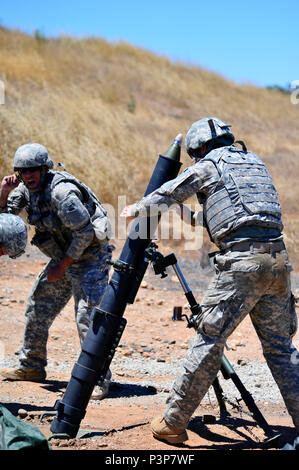 Oregon Army National Guard Soldiers with the 41st Infantry Brigade Combat Team fire mortars, July 14, during annual training at Camp Roberts, Calif. Both 1st Battalion, 186th Infantry Regiment, and 2nd Battalion, 162nd Infantry Regiment, are focusing on basic warrior skills following their return from overseas deployments last year. (Photo by Capt. Leslie Reed, 41st Infantry Brigade Combat Team Public Affairs) Stock Photo