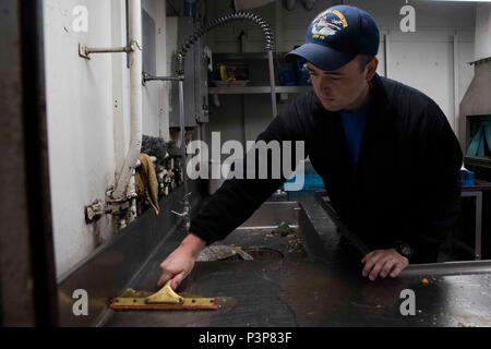 Va. (May 8, 2017) Aviation Boatswain's Mate (Handling) Airman Tyler Owen, from Rochester, N.Y., cleans a sink in a wardroom scullery aboard the aircraft carrier USS Dwight D. Eisenhower (CVN 69) (Ike). Ike is currently pier side during the sustainment phase of the Optimized Fleet Response Plan (OFRP). Stock Photo