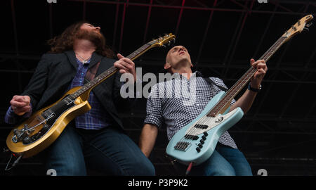 James Young (left), guitarist, and Jon Jones, bassist, come together to play a duo during a concert July 16, 2016, at Ramstein Air Base, Germany. The Eli Young Band, comprising of Young, Jones, Mike Eli, singer, and Chris Thompson, drummer, are an American country music band and have released five albums. The band has received over a dozen nominations for country music awards and have won three, including the Academy of Country Music’s song of the year for their 2011 single, “Crazy Girl.” (U.S. Air force photo/Airman 1st Class Lane T. Plummer) Stock Photo