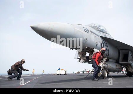 ARABIAN GULF (May 7, 2017) Sailors prepare an F/A-18F Super Hornet assigned to the 'Blacklions' of Strike Fighter Squadron (VFA) 213 for take-off from the aircraft carrier USS George H.W. Bush (CVN 77). The ship is deployed to the U.S. 5th Fleet area of operations in support of maritime security operations designed to reassure allies and partners, and preserve the freedom of navigation and the free flow of commerce in the region. Stock Photo