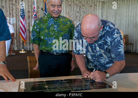 160721-N-AV234-192 PEARL HABOR (July 21, 2016) Assistant Secretary of the Navy (Energy, Installations and Environment) Dennis V. McGinn, right, signs a lease agreement between the Department of the Navy and Hawaii Electric Company alongside Governor of Hawaii David Y. Ige, left, at Historic Hickam Officers’ Club at Joint Base Pearl Harbor-Hickam.  The DON and Hawaii Electric Company are developing a solar facility on JBPHH. The project will enable the DON to meet critical energy and security goals as well as further Hawaiian Electric’s commitment to renewable energy to the state. (U.S Navy Pho Stock Photo