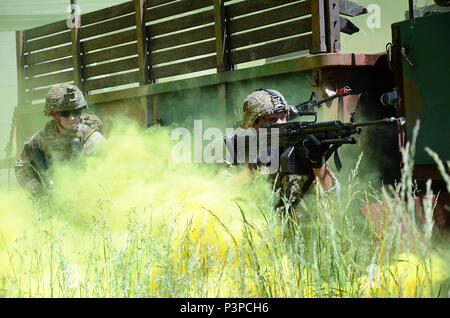 Soldiers attending the Infantryman Advanced Leader Course at the 183rd Regiment, Regional Training Institute assault an urban operations training site May 8, 2017, at Fort Pickett, Virginia. The course aims to teach infantry leaders the skills required to operate as platoon sergeants and focuses on a variety advanced of infantry leadership skills. The two-week course included approximately 40 Soldiers from both the active and reserve components. Stock Photo