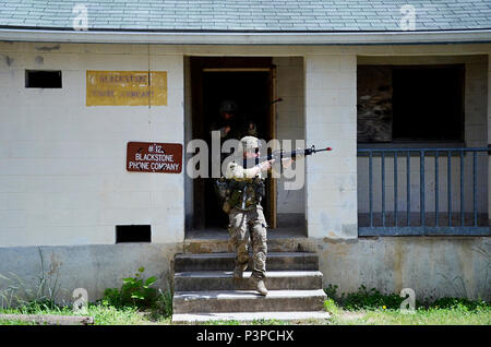 Soldiers attending the Infantryman Advanced Leader Course at the 183rd Regiment, Regional Training Institute assault an urban operations training site May 8, 2017, at Fort Pickett, Virginia. The course aims to teach infantry leaders the skills required to operate as platoon sergeants and focuses on a variety advanced of infantry leadership skills. The two-week course included approximately 40 Soldiers from both the active and reserve components. Stock Photo