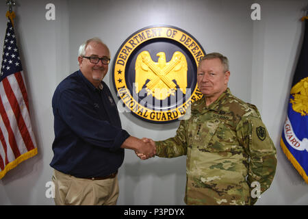 Army Gen. Frank Grass, chief, National Guard Bureau, gives Craig Fugate, administrator, Federal Emergency Management Agency, his coin for excellence in appreciation of the partnership between the National Guard and FEMA during Gen. Grass' tenure as 27th Chief of the National Guard Bureau, Minuteman Hall, the Pentagon, Washington, DC, July 22, 2016. (U.S. Army National Guard photo by Sgt. 1st Class Jim Greenhill) Stock Photo