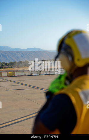160711-N-IL474-036 SOUDA BAY, Greece (July 11, 2016) Aviation Boatswain's Mate (Equipment) 3rd Class Adrian Brown, assigned to U.S. Naval Support Activity Souda Bay Air Operations Department Transient Line Division, awaits the arrival of an MV-22 Osprey.  NSA Souda Bay enables the forward operations and responsiveness of U.S. and allied forces in support of Navy Region, Europe, Africa and Southwest Asia's mission to provide services to the Fleet, Fighter, and Family. (U.S. Navy photo by Heather Judkins/Released) Stock Photo