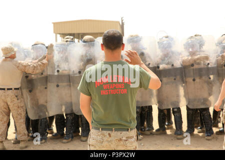 U.S. Marine Corps Cpl. Dustin Anderson, a non-lethal weapons instructor and detainee operations chief with Special Purpose Marine Air-Ground Task Force-Crisis Response-Central Command, observes Marines receive proper shielding techniques during a one-week non-lethal weapons class while forward deployed in the Middle East, May 8, 2017. The training ensures SPMAGTF Marines are prepared to respond to a variety of scenarios that may occur across the USCENTCOM area of operations. SPMAGTF-CR-CC is a well-trained crisis response unit that has the ability to project combat power over vast distances us Stock Photo