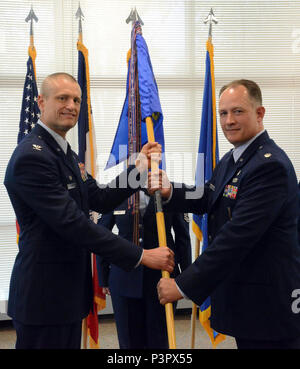 Lt. Col. Chad M. Hynnek (right), 132d Wing (132 WG) incoming Medical Group (MDG) commander and Col. Shawn D. Ford (left), commander 132 WG, pose for a photo during the exchange of the 132 WG MDG guidon during the change of command ceremony at the 132 WG MDG, Des Moines, Iowa on May 7, 2017. This action formally recognized Hynnek accepting the MDG commander role, Hynnek is the 10th commander of the MDG. Stock Photo