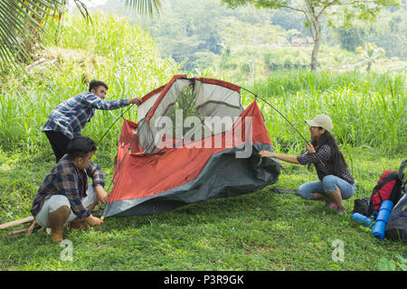 tourist help each other prepare tent Stock Photo
