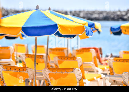 Sun umbrellas at sunny beach Stock Photo