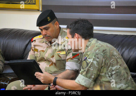 Iraqi army Col. Hassain Tamini, left, Iraqi security forces garrison commander of Camp Taji; and British army Maj. Gen. Doug Chalmers, deputy commander of strategy and sustainment, Combined Joint Task Force - Operation Inherent Resolve; discuss logistics operations on Camp Taji, Iraq, July 28, 2016. Chalmers’ visit to Camp Taji was part of a logistics symposium where Coalition and Iraqi leaders discussed ISF sustainment needs. There are more than 10 advise and assist teams, enabling ISF as they prepare for upcoming operations by sharing intelligence and developing security strategies and targe Stock Photo