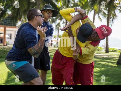 160722-M-TM809-005 DA NANG, Vietnam (July 22, 2016) Aviation Structural Mechanic 2nd Class Micah Rupp (left), from Kansas City, Missouri, assigned to hospital ship USNS Mercy (T-AH 19), teaches Vietnamese lifeguards water rescue techniques at Da Nang beach front during a Pacific Partnership 2016 lifeguard training course. During the event, Pacific Partnership personnel exchanged water survival techniques with Vietnamese lifeguards. During Pacific Partnership, partner nations are working side-by-side with local organizations to conduct cooperative health engagements, community relation events a Stock Photo