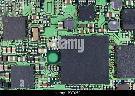 Microchips and microcircuits with ball pins are installed on a modern electronic circuit board.  SUper macro studio concept Stock Photo