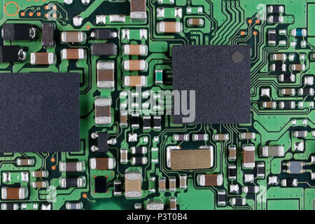 Microchips and microcircuits with ball pins are installed on a modern electronic circuit board background.  SUper macro studio  techno concept Stock Photo