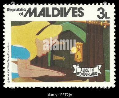 Republic of Maldives - stamp 1980: Color edition on Walt Disney, shows Alice in Wonderland and keyhole Stock Photo