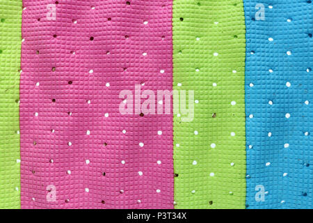 Wavy surface of strips of multi-colored soft plastic insol with holes for sweat removal Stock Photo