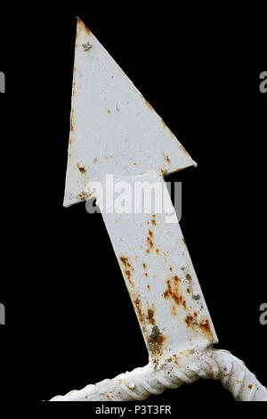 Decorative element of a rural fence - iron rusty white arrow. Isolated on black backgroun Stock Photo