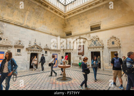 Seville Cathedral tourists, visitors move through a small fountain courtyard that serves to connect many of the chapels inside the cathedral, Spain. Stock Photo