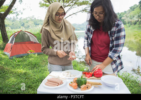 preparing food with skewers during outing Stock Photo