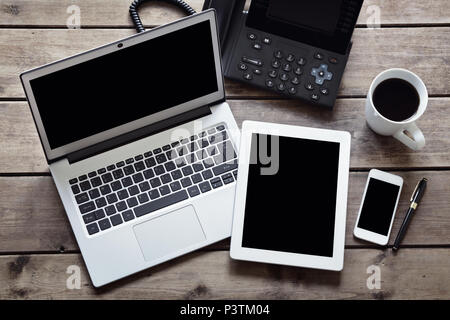 Open laptop with white digital tablet and smartphone on desk from above with isolated screen Stock Photo