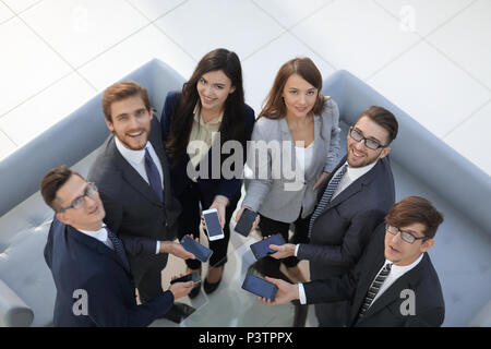 Group of  business colleagues using mobile phones in  the office Stock Photo