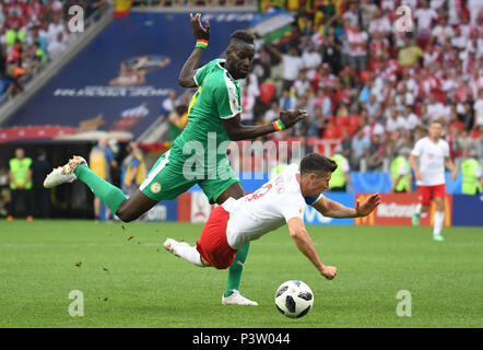 Moscow, Russia. 19th June, 2018. Soccer: World Cup 2018, group stages, group H: Poland vs Senegal at Spartak Stadium. Poland's Robert Lewandowski is stopped by Senegal's Salif Sane (L). Credit: Federico Gambarini/dpa/Alamy Live News Stock Photo