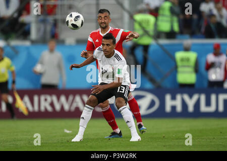 Saint Petersburg, Russia. 19th June, 2018. Egypt's Mohamed Abdel-Shafy (front) battles for the ball with Russia's Aleksandr Samedov during the FIFA World Cup 2018 Group A soccer match between Egypt and Russia, at the Saint Petersburg Stadium, in Saint Petersburg, Russia, 19 June 2018. Credit: Ahmed Ramadan/dpa/Alamy Live News Stock Photo