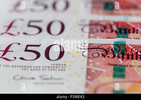 Background of a neat row of fifty UK pound bank notes sterling Stock Photo