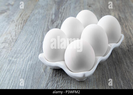 Six Large White Eggs on a White Ceramic Dish Stock Photo