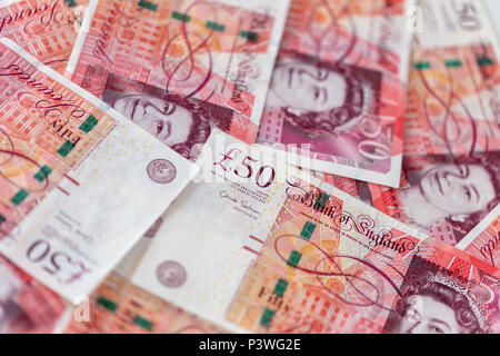 Background of scattered fifty pound bank notes sterling Stock Photo