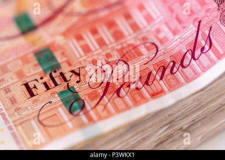 Background of a large pile of used fifty UK pound bank notes sterling Stock Photo