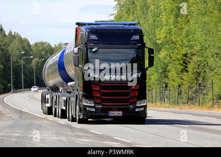 Black and red Next Generation Scania R650 tank truck of R Laakso hauls goods along highway in the summer. Kangasala, Finland - June 14, 2018. Stock Photo
