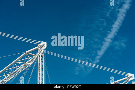 Closeup building crane against blue sky and clouds. Stock Photo