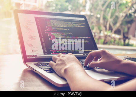 Close-up of a programmer's hands typing on a laptop keyboard. Stock Photo