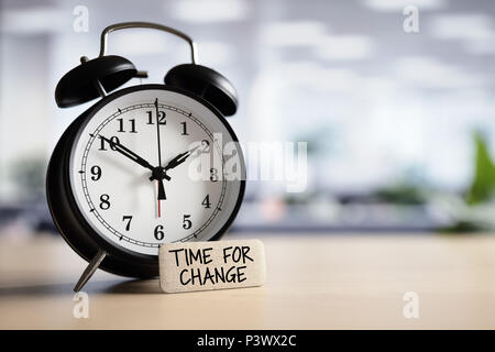 Time for change or action concept message with alarm clock on desk in office Stock Photo