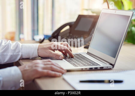 Businessman using laptop computer in office Stock Photo