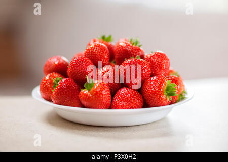 Fresh strawberries in a white bowl Stock Photo