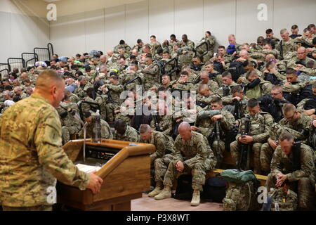 Soldiers assigned to the 389th Engineer Company and the 176th Engineer Brigade are led in prayer during the farewell brief at the Silas L. Copeland Airfield Control Group moments before boarding their flight to the Middle East July 29. Stock Photo