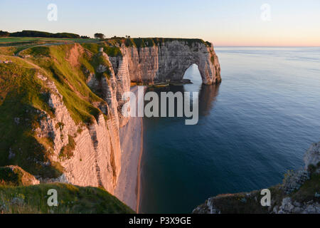 Etretat (northern France), town along the 'Cote d'Albatre' (Norman coast), in the area called 'pays de Caux'. The 'Manneporte' sea stack at nightfall Stock Photo