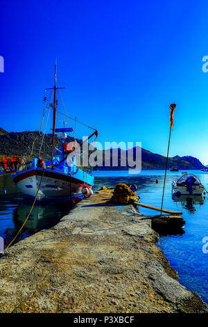 Fishing boats from waters edge in Pedi Bay, Symi, Greece Stock Photo