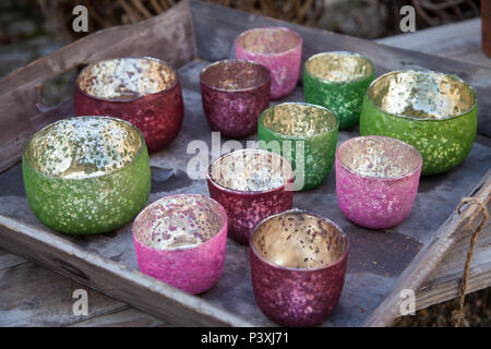 Colorful tealight candle holders on a tray Stock Photo