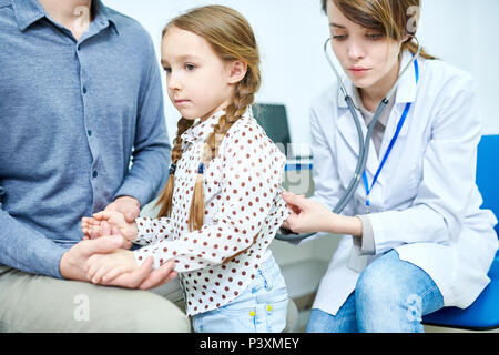 Young father with daughter at pediatrician reception Stock Photo