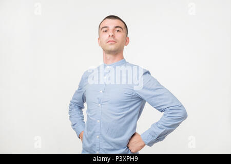 Handsome young man standing like a super hero. He is proud of himself Stock Photo