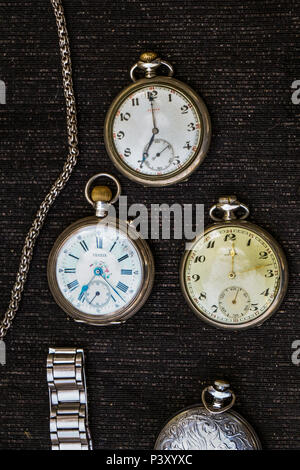 Retro style pocket watch placed on a piece of fabric Stock Photo