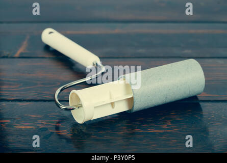 lint roller adhesive tape on wood table. Stock Photo