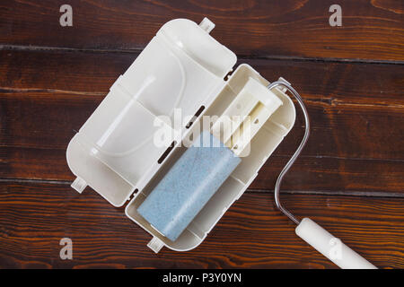 lint roller adhesive tape on wood table. Stock Photo